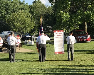Neighbors | Alexis Bartolomucci.The color guard placed the flag before the Canfield Community Concert Band played at Austintown Park on June 27.