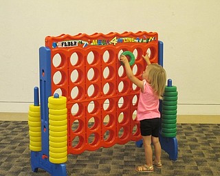Neighbors | Alexis Bartolomucci.One of the children at the Austintown library played a giant came of "Connect Four" during the Family Game Night on July 10.