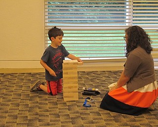 Neighbors | Alexis Bartolomucci.Guests played a game of giant "Jenga" on July 10 for the Austintown library's Family Game Night program.