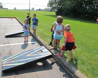 Neighbors | Alexis Bartolomucci.Children waited for the pony rides at the Boardman library on July 19 and played games of cornhole to pass the time.