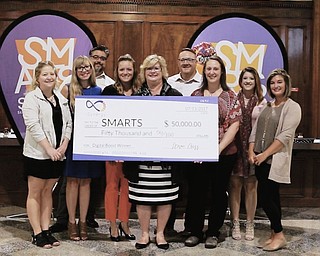 Above are members of Students Motivated by the Arts who have been awarded $50,000 in services from iSynergy of Boardman after winning a local contest. Above, from left, are Michaela Good, iSynergy staff; Josie Puskar, iSynergy staff; Chris Anthony, iSynergy staff; McKenzie Cross, iSynergy staff; Becky Keck, executive director of SMARTS; Steve Cross, owner iSynergy; Caroline Lorimer, program director SMARTS; Carson Fryman, iSynergy staff; and Emily Diorio, iSynergy staff.