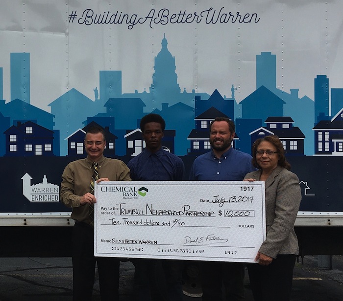 Trumbull Neighborhood Partnership has received $10,000 in support from Chemical Bank for Building A Better Warren, a jobs program that employs local residents in neighborhood revitalization plans and blight reduction. The program emphasizes hiring low- and moderate-income workers for jobs that improve Trumbull County neighborhoods. The positions offer health coverage to employees after 90 days of full-time employment. Above, from left, are Donnie Fatobene, Chemical Bank; Quantis McNair, TNP’s Building a Better Warren team member; Matt Martin, executive director of TNP; and Ky Pegues, CRA market manager at the bank.