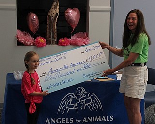 Neighbors | Abby Slanker.Kindergartner Brynna Jones presented a check for $1,000, which she raised by having bake sales, to Angels for Animals co-founder Diane Less on June 3.