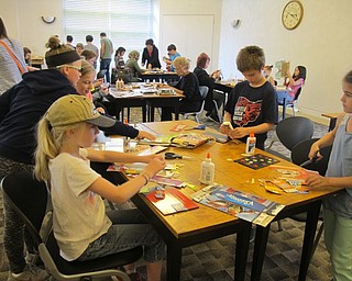 Neighbors | Alexis Bartolomucci.Children created pop art using empty boxes and cutting them into pieces during artist Michael Albert's visit to the Austintown library on June 27.