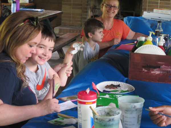 Neighbors | Alexis Bartolomucci.Children painted colors on their hands to make flowers on a canvas during Camp FRIEND on June 29 at Boardman Park.
