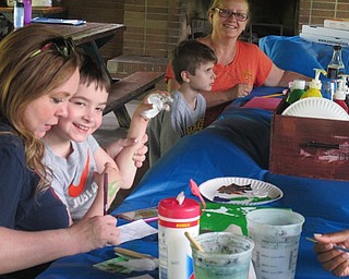 Neighbors | Alexis Bartolomucci.Children painted colors on their hands to make flowers on a canvas during Camp FRIEND on June 29 at Boardman Park.