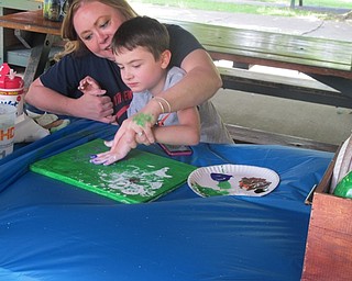 Neighbors | Alexis Bartolomucci.Tracy and her son painted a flower on canvas during craft time at Boardman Park as part of Camp FRIEND.