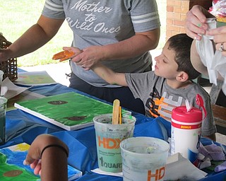 Neighbors | Alexis Bartolomucci.Children got their hands painted so they could make handprint flowers during the craft day of Camp FRIEND on June 29.