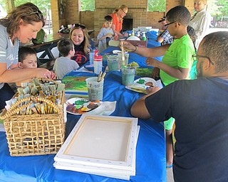 Neighbors | Alexis Bartolomucci.Children used acrylic paints and canvas to create handprint flowers during craft day during the Camp FRIEND family week.