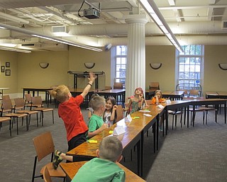 Neighbors | Alexis Bartolomucci.Children in the Spanish for Bigger Kids program at the Poland library tossed a ball to each other to practice saying their names in spanish.
