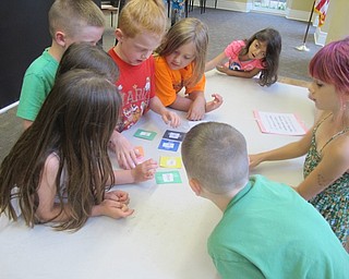 Neighbors | Alexis Bartolomucci.Children put a message together using clues to find out what the last piece of the puzzle was during the scavenger hunt at Poland library's Hablamos Espanol program.