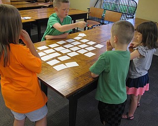 Neighbors | Alexis Bartolomucci.A memory game was set up for the children to match the Spanish word to the number as part of the Hablamos Spanish program at the Poland library.
