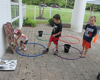 Neighbors | Alexis Bartolomucci.Children played a dog-themed game during the Pooch-a-Palooza program on July 19 at the Austintown Library.