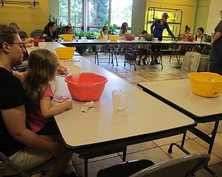Neighbors | Alexis Bartolomucci.Children at Fellows Riverside Gardens Sprout Club program mixed together ingredients to make their own play dough.