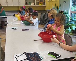 Neighbors | Alexis Bartolomucci.One of the girls kneaded together her play dough she made at Sprout Club at Fellows Riverside Gardens on July 20.
