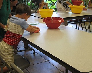 Neighbors | Alexis Bartolomucci.Children played with their play dough after they finished mixing in the ingredients during the Sprout Club program on July 20.