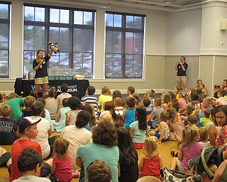 Neighbors | Alexis Bartolomucci.Children gathered at the Canfield library on July 21 to see an African Penguin brought in by the WAVE Foundation in Cincinnati.
