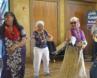 Neighbors | Alexis Bartolomucci.Seniors did some hula dancing to live music for the senior day luau event at Boardman Park.