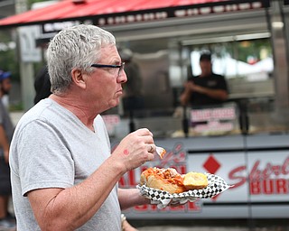 Dana Foster of Farrell, Pa. enjoys a toasted cavatelli bread bowl during the Greater Youngstown Italian Festival, Friday, August 4, 2017 in Downtown Youngstown...(Nikos Frazier | The Vindicator)