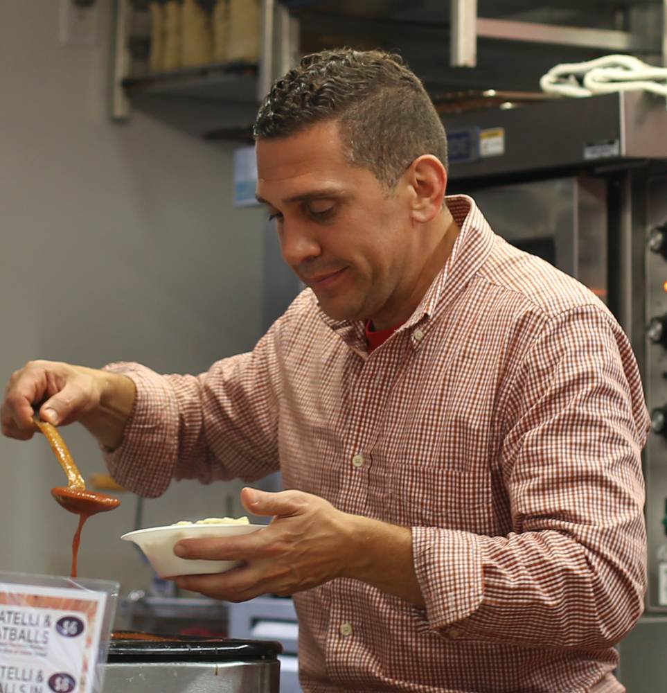 Frank LaRocca of Pasqualle La Rocca Concessions spoons some sauce onto a cavatelli bowl during the Greater Youngstown Italian Festival, Friday, August 4, 2017 in Downtown Youngstown...(Nikos Frazier | The Vindicator)