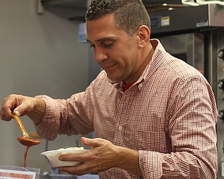 Frank LaRocca of Pasqualle La Rocca Concessions spoons some sauce onto a cavatelli bowl during the Greater Youngstown Italian Festival, Friday, August 4, 2017 in Downtown Youngstown...(Nikos Frazier | The Vindicator)
