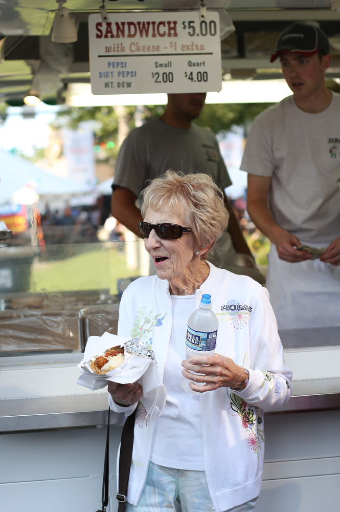 Jean Freaney of Canfield smiles as she walks away with a DiRusso's italian sausage sandwich during the Greater Youngstown Italian Festival, Saturday, August 5, 2017 in Downtown Youngstown...(Nikos Frazier | The Vindicator)
