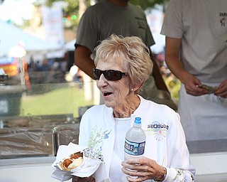Jean Freaney of Canfield smiles as she walks away with a DiRusso's italian sausage sandwich during the Greater Youngstown Italian Festival, Saturday, August 5, 2017 in Downtown Youngstown...(Nikos Frazier | The Vindicator)