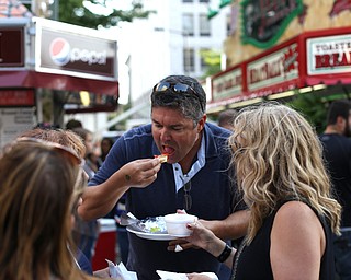 Adam Burke of Sandy Springs, Ga. enjoys a strombolli from LaRocca during the Greater Youngstown Italian Festival, Saturday, August 5, 2017 in Downtown Youngstown...(Nikos Frazier | The Vindicator)