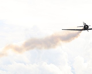 A plane flies trailing smoke during the 5th Annual Wings and Wheels, Sunday, August 6, 2017 at Ernie Hall Aviation Museum in Warren...(Nikos Frazier | The Vindicator)