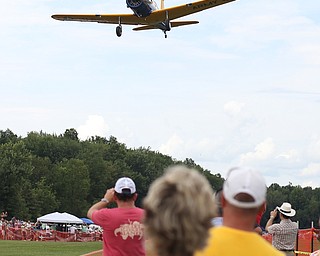 A plane makes a low pass over spectators during the 5th Annual Wings and Wheels, Sunday, August 6, 2017 at Ernie Hall Aviation Museum in Warren...(Nikos Frazier | The Vindicator)