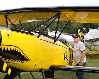 Tom Dorn of Columbiana looks over a biplane during the 5th Annual Wings and Wheels, Sunday, August 6, 2017 at Ernie Hall Aviation Museum in Warren...(Nikos Frazier | The Vindicator)