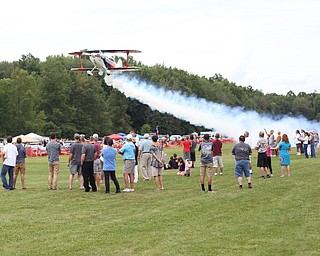 A plane makes a low pass over spectators during the 5th Annual Wings and Wheels, Sunday, August 6, 2017 at Ernie Hall Aviation Museum in Warren...(Nikos Frazier | The Vindicator)