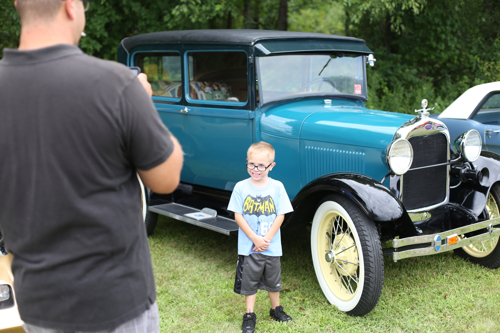 Eric Freeman of Niles takes a photo of his son, Levi(6) in front of an old Ford during the 5th Annual Wings and Wheels, Sunday, August 6, 2017 at Ernie Hall Aviation Museum in Warren...(Nikos Frazier | The Vindicator)