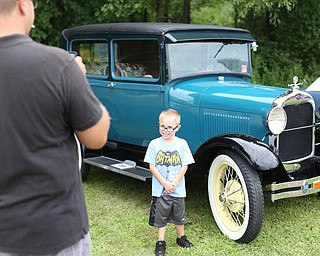 Eric Freeman of Niles takes a photo of his son, Levi(6) in front of an old Ford during the 5th Annual Wings and Wheels, Sunday, August 6, 2017 at Ernie Hall Aviation Museum in Warren...(Nikos Frazier | The Vindicator)