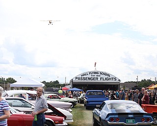 A plane makes a low pass over spectators during the 5th Annual Wings and Wheels, Sunday, August 6, 2017 at Ernie Hall Aviation Museum in Warren...(Nikos Frazier | The Vindicator)