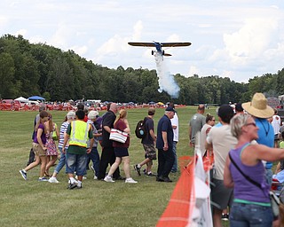 A plane makes a low pass over spectators during the 5th Annual Wings and Wheels, Sunday, August 6, 2017 at Ernie Hall Aviation Museum in Warren...(Nikos Frazier | The Vindicator)