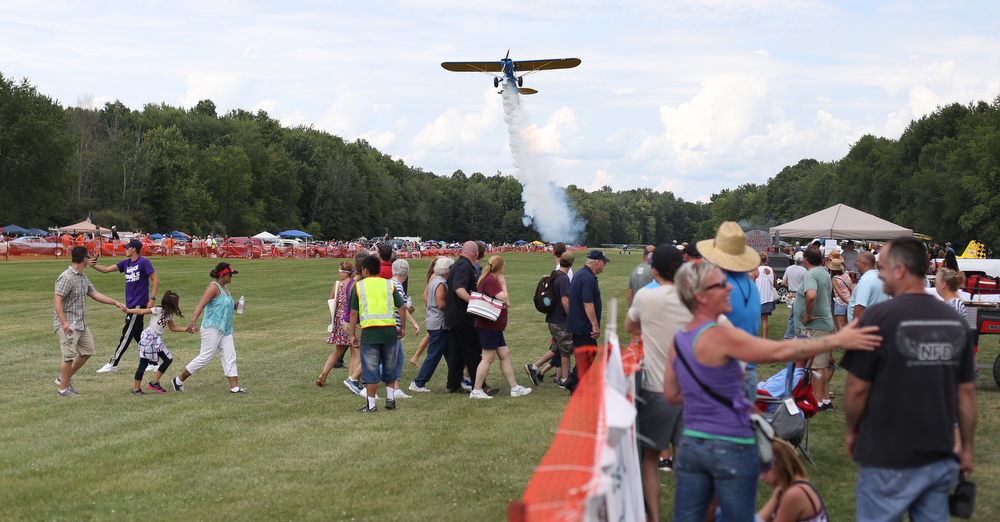 A plane makes a low pass over spectators during the 5th Annual Wings and Wheels, Sunday, August 6, 2017 at Ernie Hall Aviation Museum in Warren...(Nikos Frazier | The Vindicator)