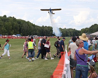 A plane makes a low pass over spectators during the 5th Annual Wings and Wheels, Sunday, August 6, 2017 at Ernie Hall Aviation Museum in Warren...(Nikos Frazier | The Vindicator)