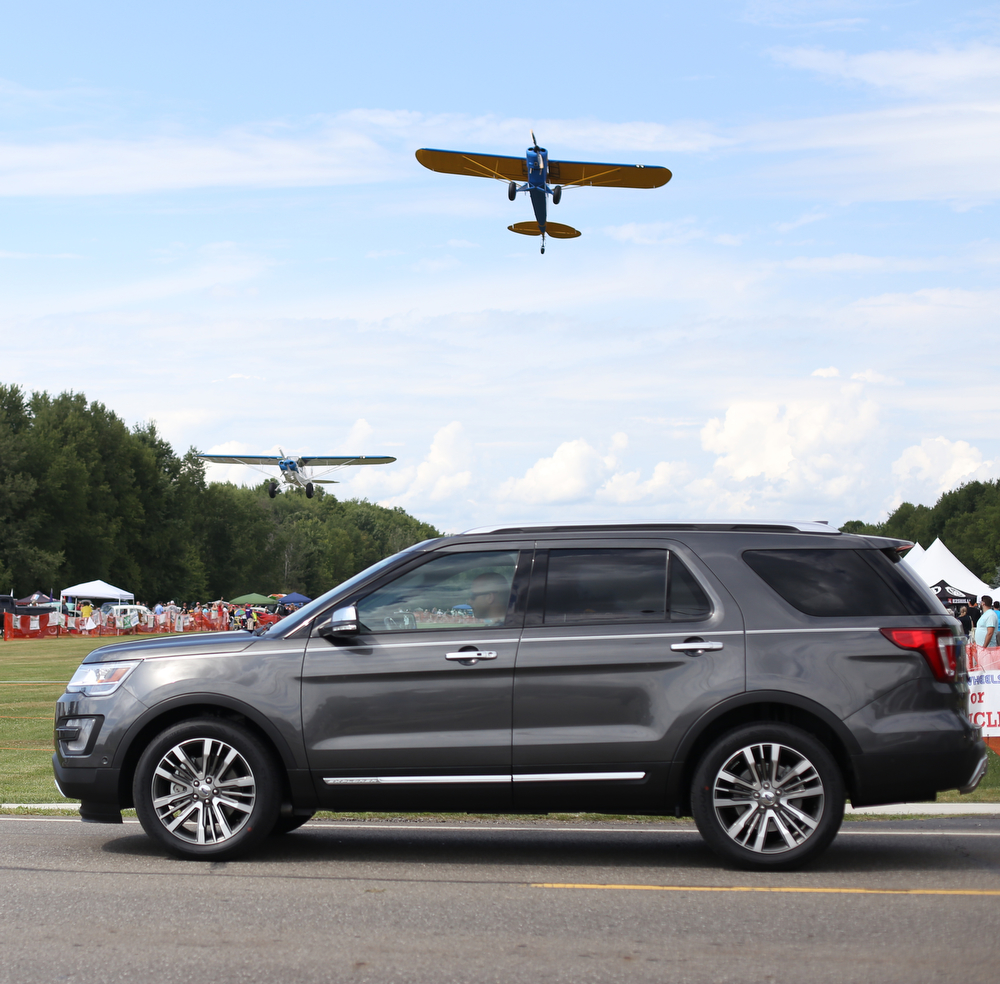 A plane makes a low pass over spectators during the 5th Annual Wings and Wheels, Sunday, August 6, 2017 at Ernie Hall Aviation Museum in Warren...(Nikos Frazier | The Vindicator)