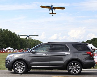 A plane makes a low pass over spectators during the 5th Annual Wings and Wheels, Sunday, August 6, 2017 at Ernie Hall Aviation Museum in Warren...(Nikos Frazier | The Vindicator)
