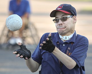 ROBERT K. YOSAY | THE VINDICATOR..Tom Glines of Youngstown makes a play at first as The Adaptive Sports Program of Ohio - wheelchair softball - at the Covelli Centre parking lot