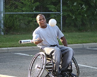 ROBERT K. YOSAY | THE VINDICATOR.Liston Spann of Youngstown prepares to tag the pitch... as The Adaptive Sports Program of Ohio - wheelchair softball - at the Covelli Centre parking lot