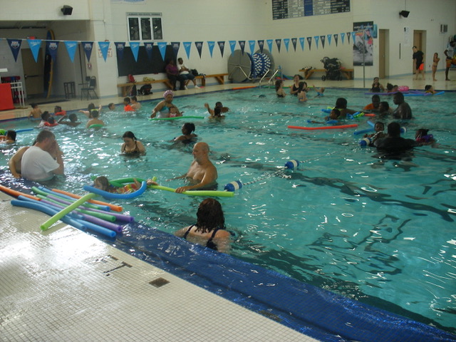The Hubbard Community Pool held its 13th annual free swim party July 15 to thank Hubbard and surrounding communities for their support. The day began with a 5K run followed by a free swim. It also included food and a basket auction. Above, attendees enjoy the free swim. Below, Christian Stanton and Shel Fuchs enjoy attending the event.
