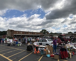 Neighbors | Alexis Bartolomucci.Vendors set up tables at the St. Christine parking lot on Aug. 5 to sell different items for the Trunk and Treasure sale.