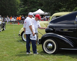 Neighbors | Abby Slanker.Members of the Mahoning Valley Olde Car Club conferred as they judged a vehicle at the club’s Cars in the Park Car Show and Flea Market on Aug. 6. This is the 39th year for the event.