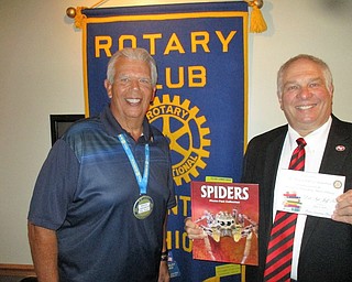 Jeff Toth, Austintown DARE officer, spoke recently to members of the Rotary Club of Austintown. A veteran of 17 years, Toth will get some help when a new DARE officer joins the force with a specialty in drug and alcohol resistance education. Toth works with kindergarten, first-, third-, fifth- and seventh-graders, stressing the dangers of drugs and alcohol in their lives. He said the Austintown police maintain a drop-off site for expired and unneeded prescriptions at the police station. Above, from left is Rotary President Bruce Laraway presenting a book to Toth that will be donated in his honor to the library at Austintown Elementary School.