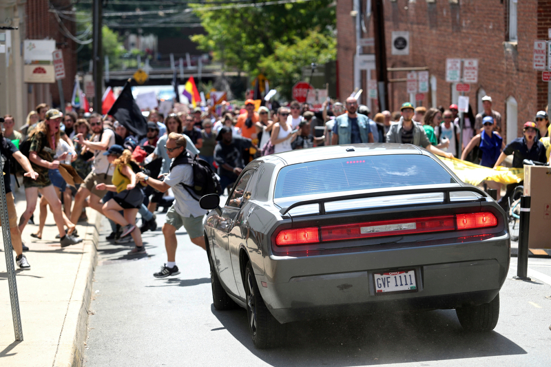 A vehicle drives into a group of protesters demonstrating against a white nationalist rally in Charlottesville, Va., Saturday, Aug. 12, 2017. The nationalists were holding the rally to protest plans by the city of Charlottesville to remove a statue of Confederate Gen. Robert E. Lee. There were several hundred protesters marching in a long line when the car drove into a group of them.   /The Daily Progress via AP)