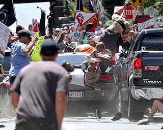 People fly into the air as a vehicle drives into a group of protesters demonstrating against a white nationalist rally in Charlottesville, Va., Saturday, Aug. 12, 2017. The nationalists were holding the rally to protest plans by the city of Charlottesville to remove a statue of Confederate Gen. Robert E. Lee. There were several hundred protesters marching in a long line when the car drove into a group of them. (Ryan M. Kelly/The Daily Progress via AP)