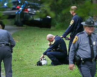Authorities work near the scene of a deadly helicopter crash near Charlottesville, Va., on Saturday Aug. 12, 2017. (Shelby Lum/Richmond Times-Dispatch via AP)