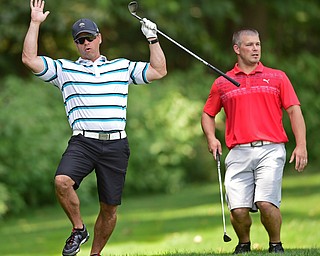 POLAND, OHIO - AUGUST 14, 2017: Jamie Palumbo, white, and Scott Hoff, red, react after Palumbo's approach shot just missed the hole on the 15th hole during the 2017 Greatest Golfer of the Valley scramble at the Lake Club. DAVID DERMER | THE VINDICATOR